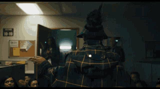 A gif of a woman cocking her head to the right as she flips through different universes each time she cocks her head to the right like turning a dial to different stations on a radio all while the camera remains focused on her from behind her back  as seen in the movie 'Everything Everywhere All at Once'.