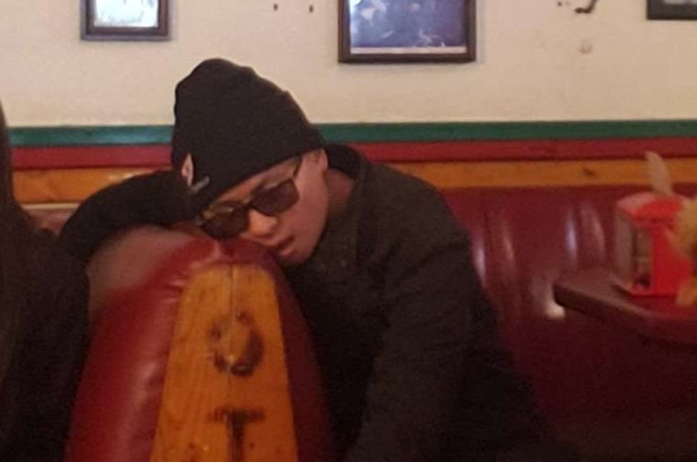 A picture of me fainted and my face smashed against the couch with my right arm hanging over the seat and my other arm dropping down.